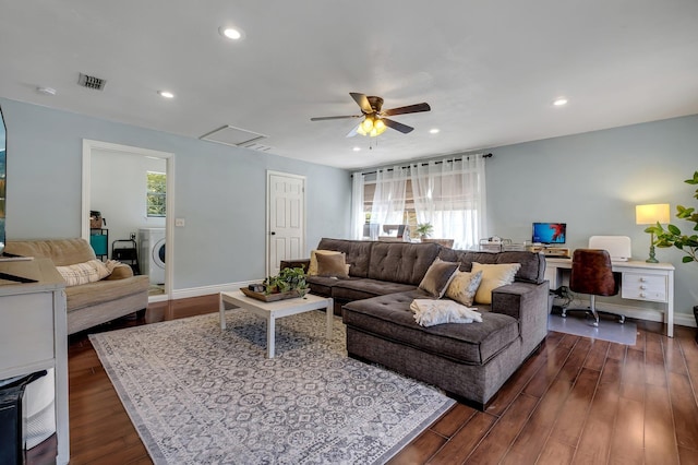 living room with washer / clothes dryer, ceiling fan, and dark wood-type flooring