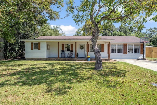 ranch-style home with a porch and a front yard