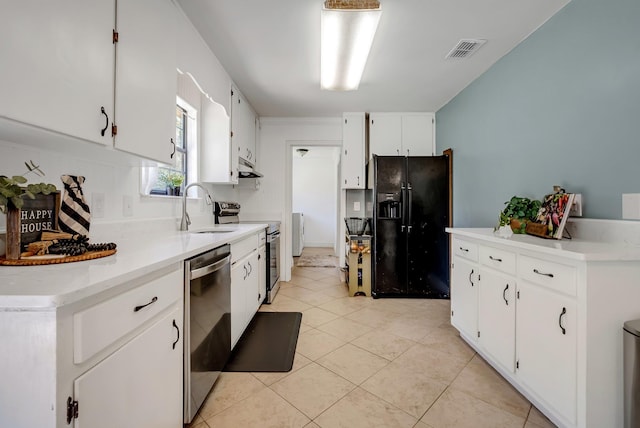 kitchen featuring light tile patterned flooring, stainless steel appliances, white cabinetry, and sink