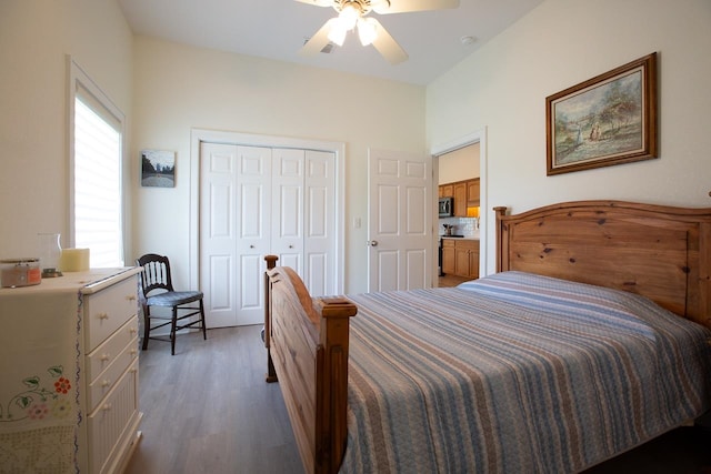 bedroom with ceiling fan, dark hardwood / wood-style floors, and a closet