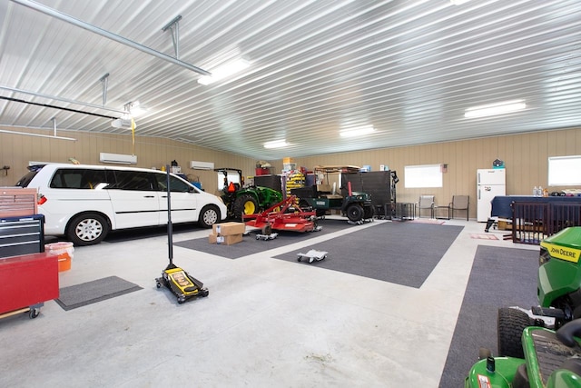 garage featuring wood walls