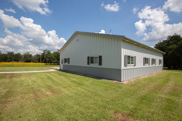 view of side of home with a yard