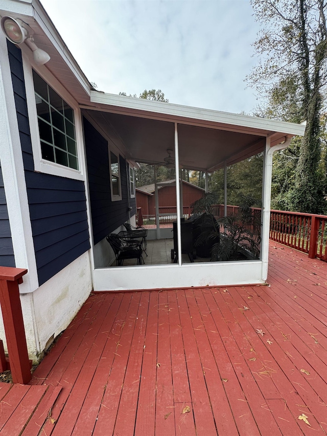 wooden deck featuring a sunroom