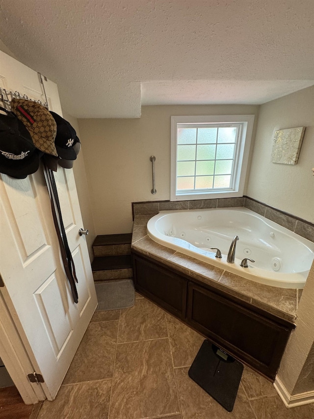 bathroom featuring a textured ceiling and a bathing tub