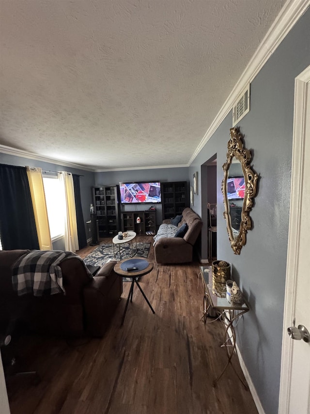 living room with hardwood / wood-style flooring, ornamental molding, and a textured ceiling