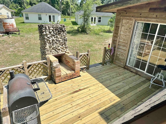 wooden deck featuring a yard