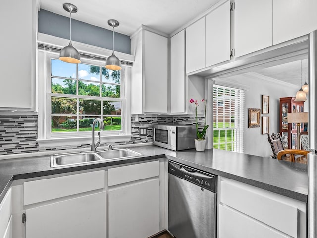 3267 Rue De Lafitte Dr, Tallahassee, FL 32312 - kitchen with stainless steel appliances, white cabinetry, tasteful backsplash, dark countertops, and crown molding