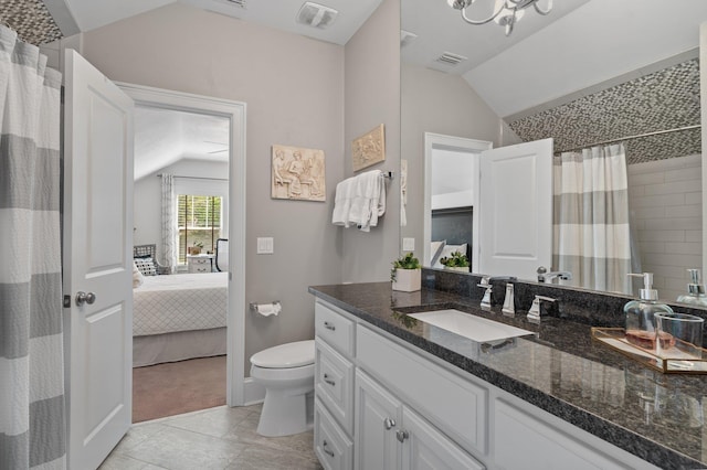1216 Mitchell Ave, Tallahassee, FL 32303 - ensuite bathroom featuring toilet, connected bathroom, vanity, lofted ceiling, and visible vents