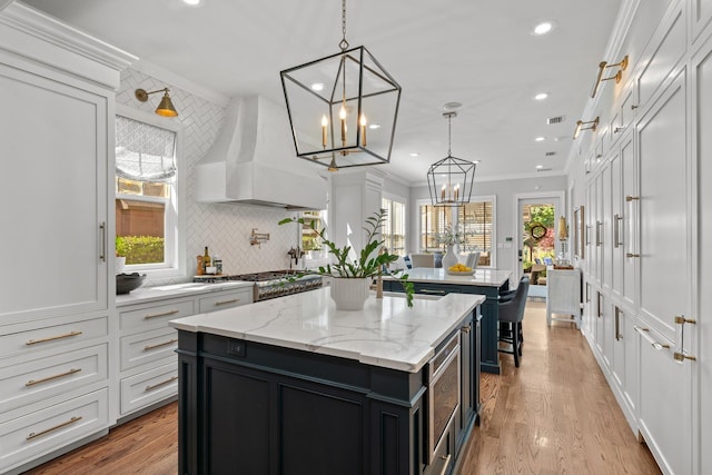 1216 Mitchell Ave, Tallahassee, FL 32303 - kitchen with recessed lighting, backsplash, premium range hood, a center island, and a notable chandelier