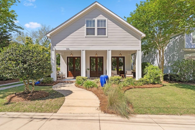 1216 Mitchell Ave, Tallahassee, FL 32303 - bungalow-style home featuring covered porch, french doors, and a front yard