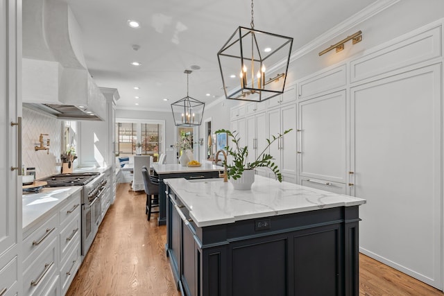 1216 Mitchell Ave, Tallahassee, FL 32303 - kitchen featuring a notable chandelier, premium range hood, crown molding, a center island, and white cabinetry