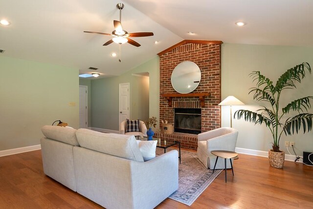 696 Lupine Ln, Tallahassee, FL 32308 - living room with a ceiling fan, wood finished floors, lofted ceiling, a fireplace, and recessed lighting