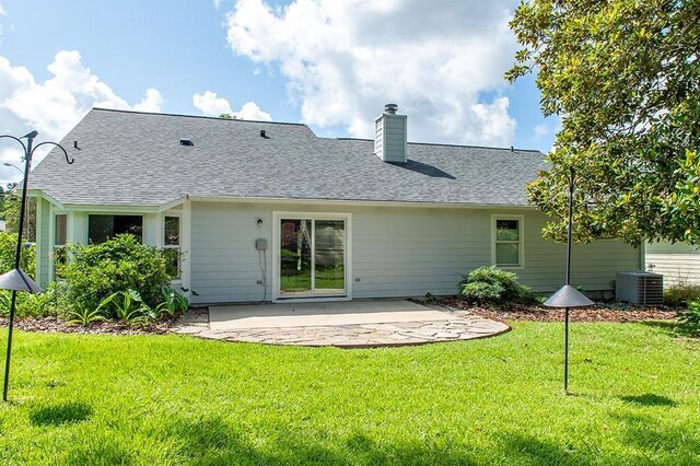 696 Lupine Ln, Tallahassee, FL 32308 - rear view of property with a patio, a shingled roof, a yard, and a chimney