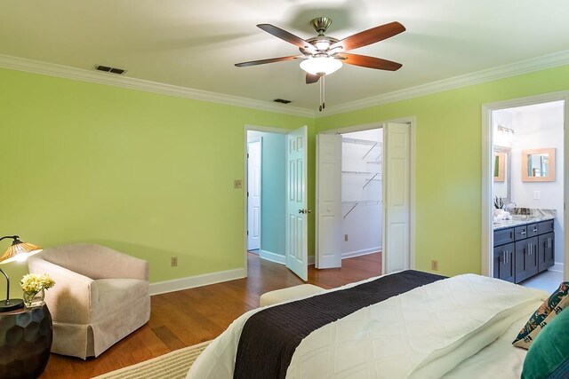 696 Lupine Ln, Tallahassee, FL 32308 - bedroom featuring ornamental molding, wood finished floors, ensuite bath, a ceiling fan, and a closet