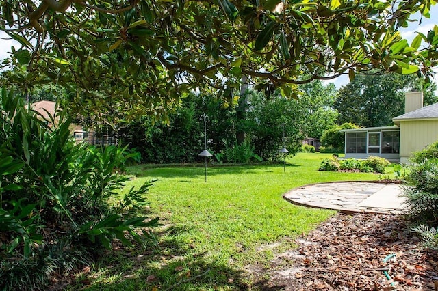 696 Lupine Ln, Tallahassee, FL 32308 - view of green lawn featuring a sunroom and a patio area