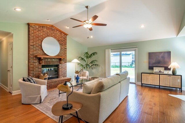 696 Lupine Ln, Tallahassee, FL 32308 - living room featuring a ceiling fan, lofted ceiling, wood finished floors, and a fireplace