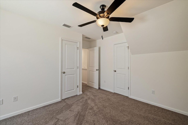 unfurnished bedroom featuring ceiling fan, carpet flooring, and vaulted ceiling