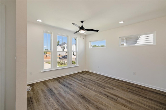 empty room featuring ceiling fan and dark hardwood / wood-style flooring