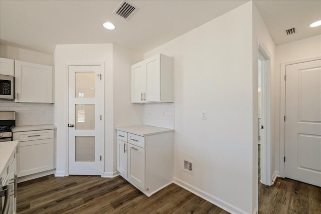 kitchen featuring white cabinetry, dark wood-type flooring, and backsplash