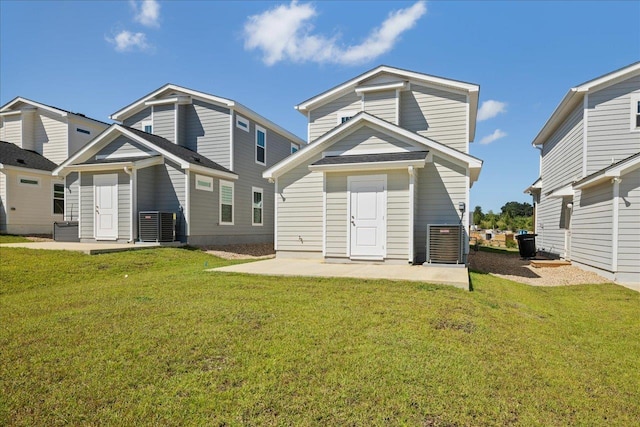 back of property with a patio area, central air condition unit, and a lawn