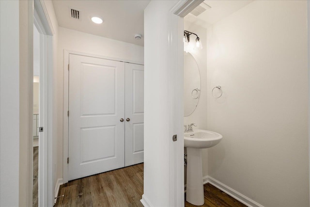 bathroom with sink and wood-type flooring