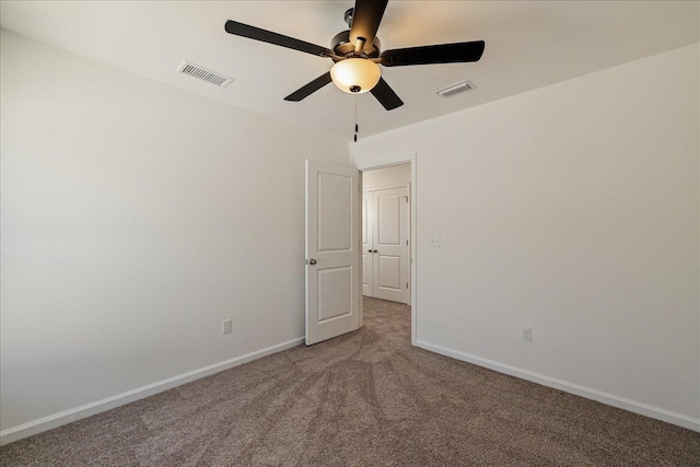 spare room with ceiling fan and carpet flooring