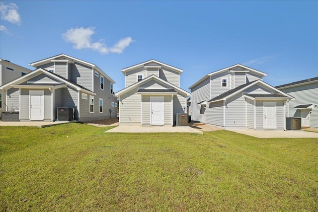 rear view of house featuring a patio, a lawn, and central air condition unit