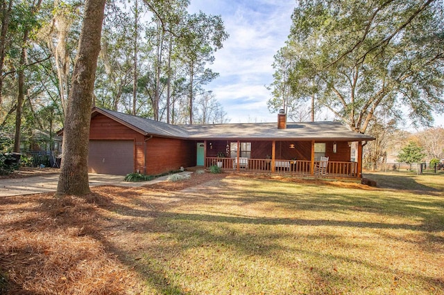 single story home featuring a garage, a front yard, and a porch