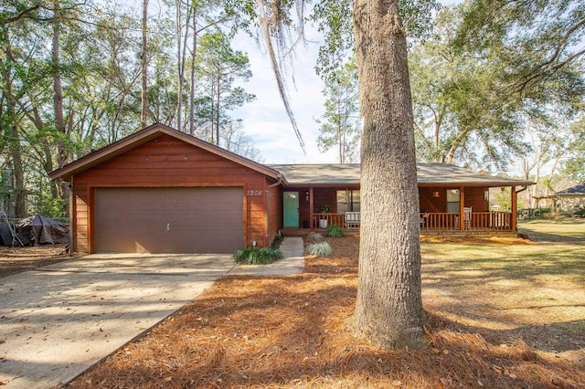 ranch-style home with a garage and covered porch