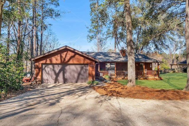 single story home featuring a porch and a garage