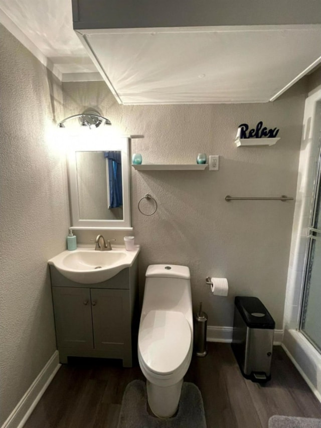 full bathroom featuring toilet, vanity, hardwood / wood-style flooring, and shower / bath combination with glass door