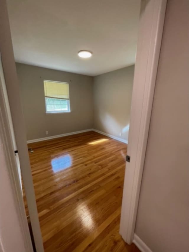 empty room featuring hardwood / wood-style flooring