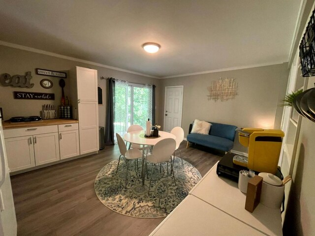 living room featuring dark hardwood / wood-style flooring and ornamental molding