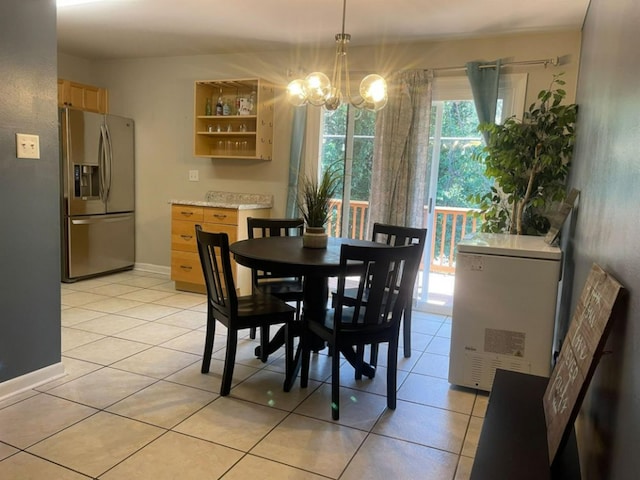dining room with a chandelier and light tile patterned flooring