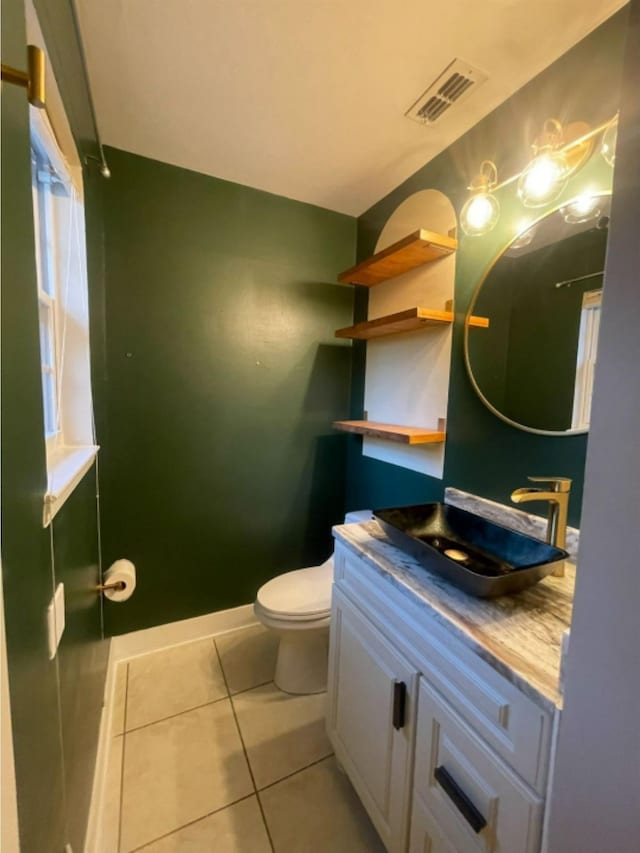 bathroom featuring vanity, tile patterned flooring, and toilet