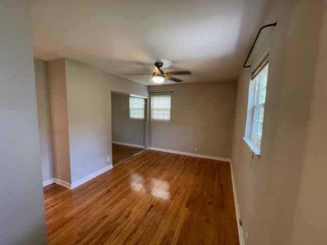empty room featuring light wood-type flooring and ceiling fan