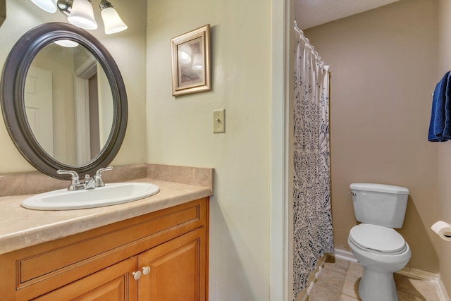 bathroom with vanity, toilet, and tile patterned flooring