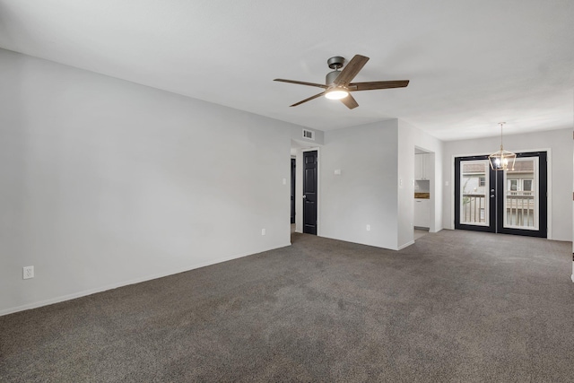 empty room with dark colored carpet, french doors, and ceiling fan