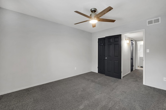 unfurnished bedroom featuring ceiling fan, a closet, and dark carpet