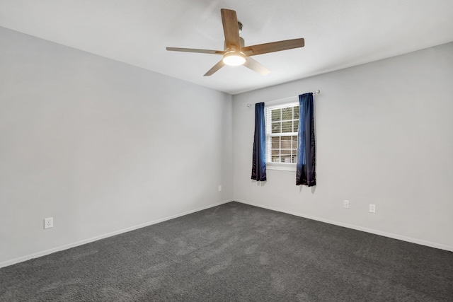 unfurnished room featuring ceiling fan and dark colored carpet