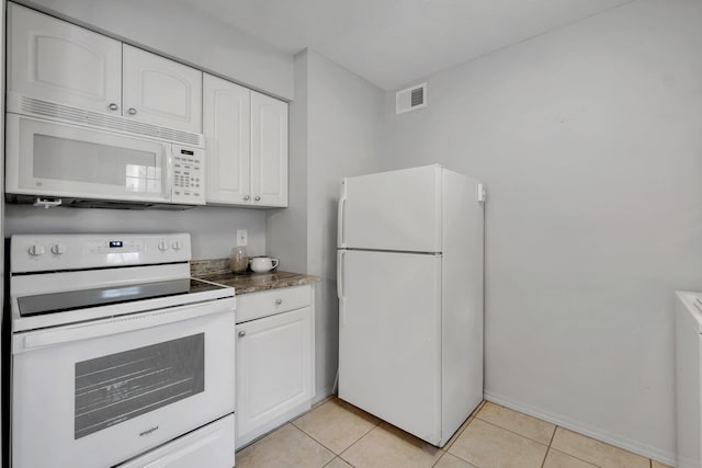 kitchen featuring light tile patterned floors, white appliances, and white cabinetry