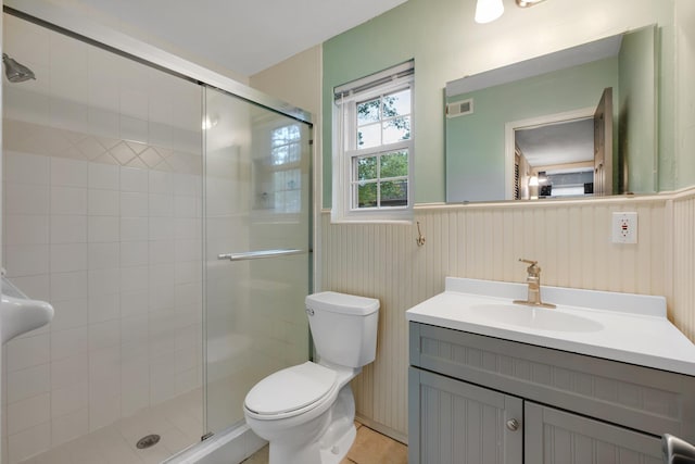 bathroom with walk in shower, wooden walls, vanity, and toilet