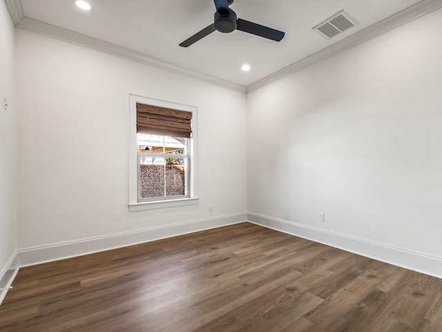 empty room featuring ceiling fan, ornamental molding, and dark wood-type flooring