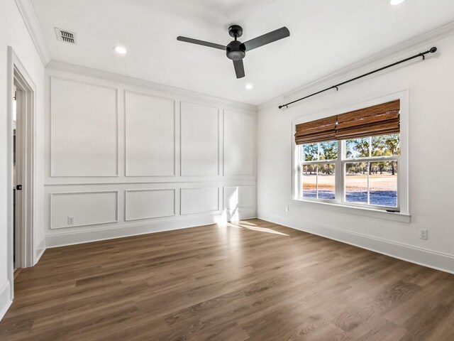 interior space featuring ceiling fan, ornamental molding, and dark wood-type flooring