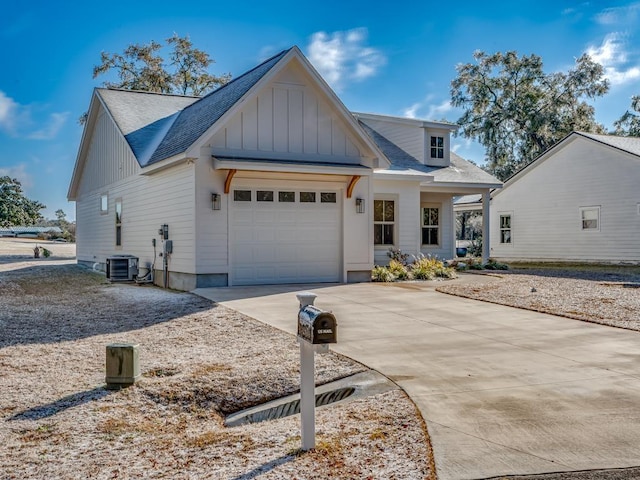 view of front of house with a garage and cooling unit