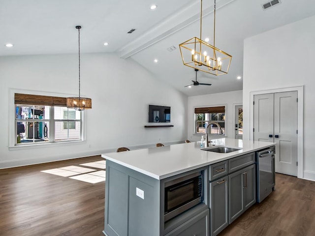 kitchen with sink, beam ceiling, gray cabinets, a center island with sink, and stainless steel appliances