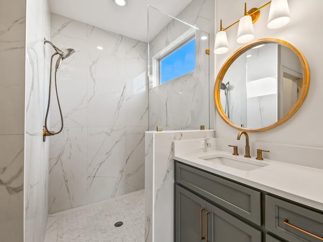 bathroom with vanity and a tile shower