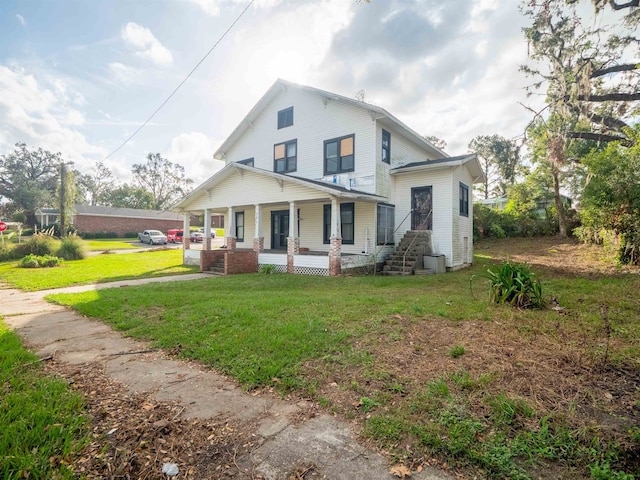 rear view of property with a lawn and a porch