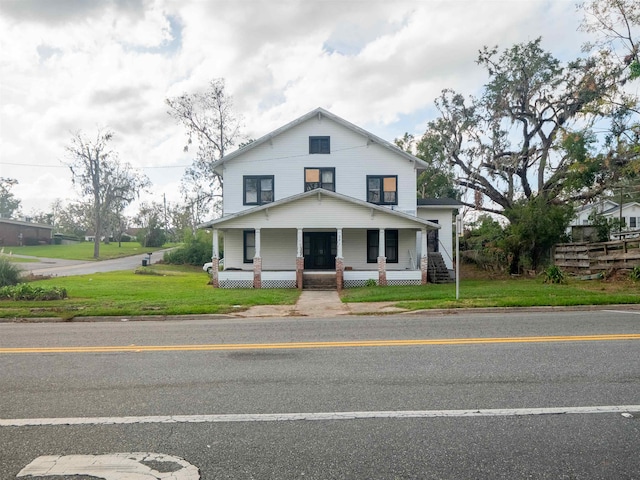 view of front of home featuring covered porch and a front yard