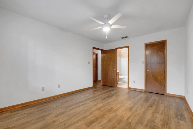 unfurnished bedroom featuring ceiling fan, ensuite bathroom, and light hardwood / wood-style flooring